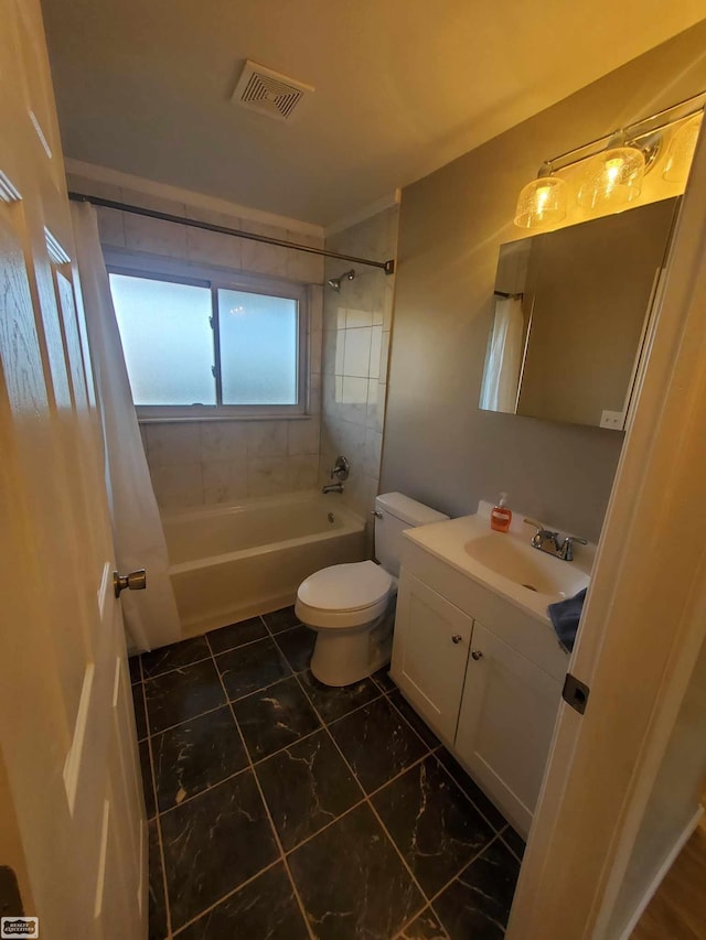 full bathroom with tiled shower / bath combo, toilet, and vanity