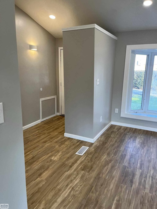 spare room featuring dark wood-type flooring