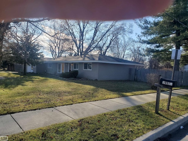 ranch-style home with a front lawn