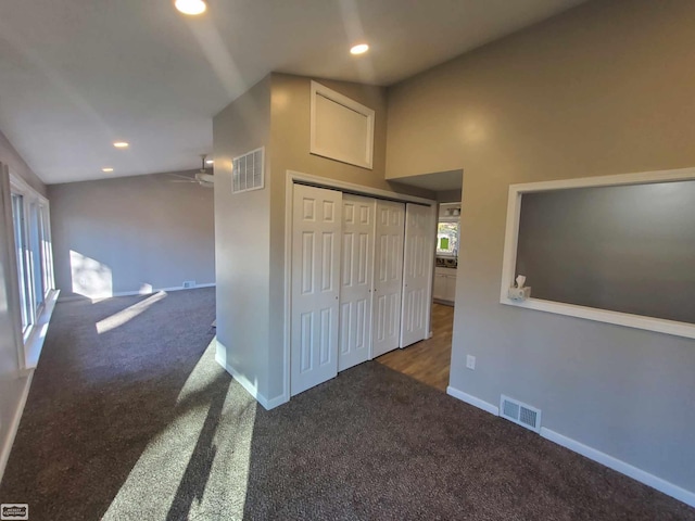 corridor with dark colored carpet