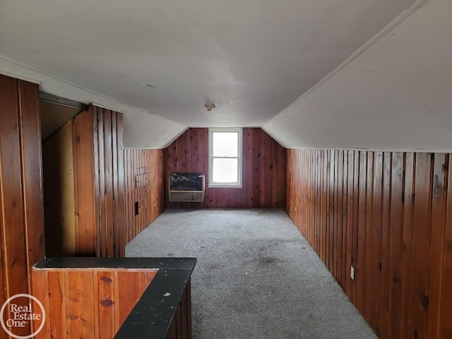 bonus room featuring carpet flooring, heating unit, vaulted ceiling, and wooden walls