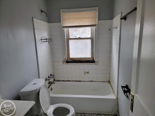 bathroom featuring toilet and tiled shower / bath