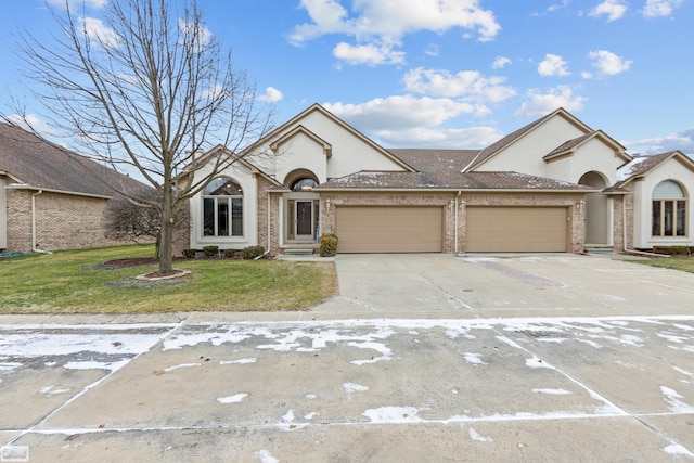 view of front of property with a garage and a front lawn