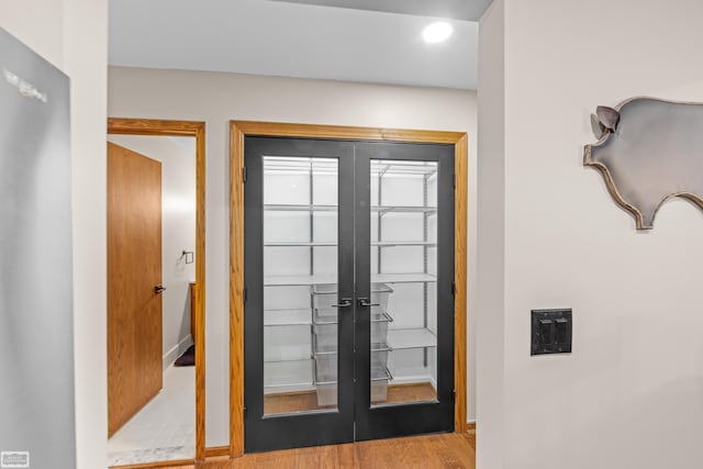 doorway to outside featuring french doors and light hardwood / wood-style floors