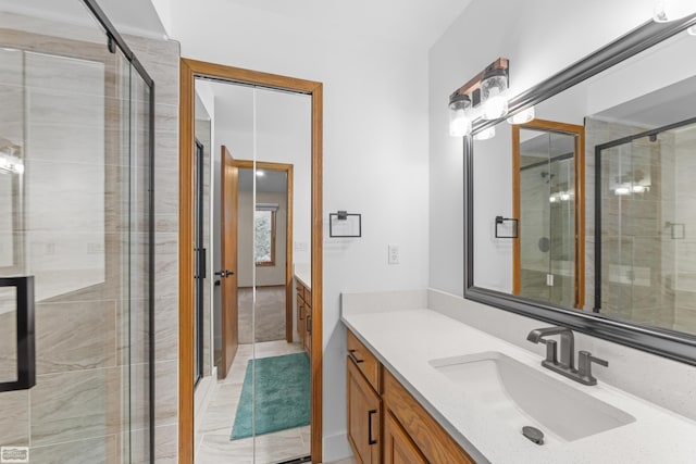 bathroom featuring tile patterned flooring, vanity, and an enclosed shower