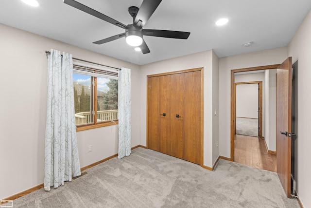 carpeted bedroom featuring ceiling fan and a closet