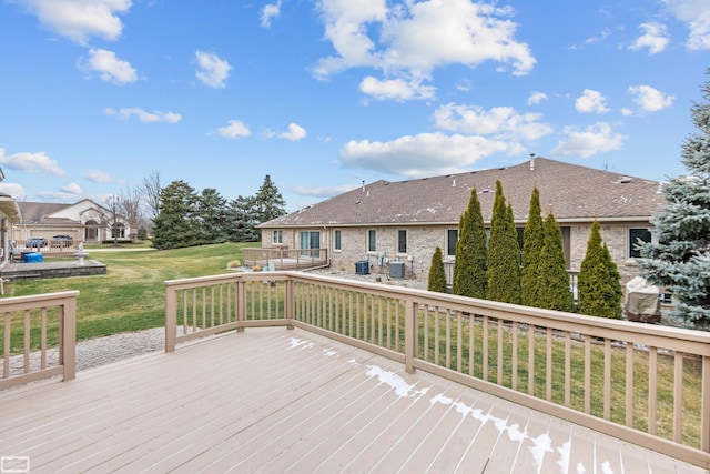 deck featuring central AC and a lawn