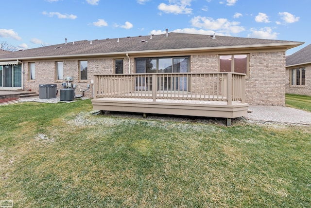 rear view of house featuring central AC, a lawn, and a wooden deck