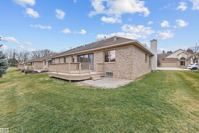 rear view of house featuring a deck and a lawn