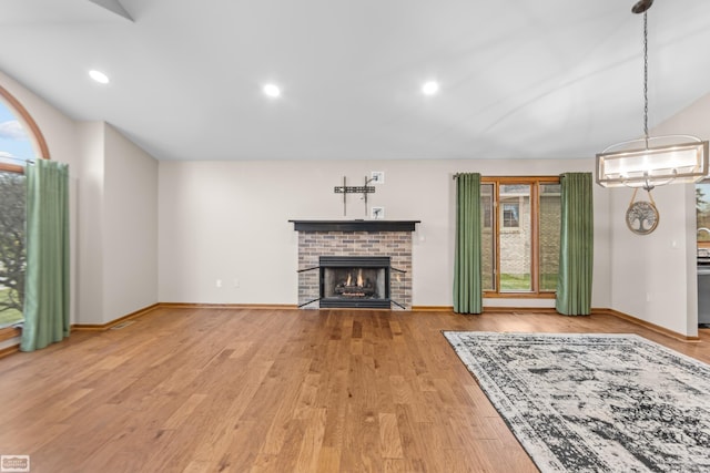 unfurnished living room with hardwood / wood-style floors and a fireplace