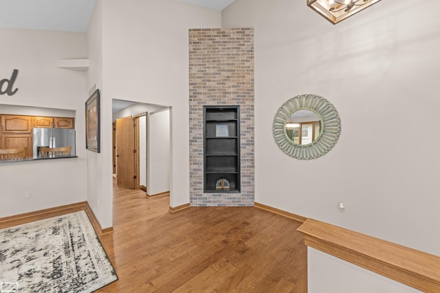 living room with high vaulted ceiling and light hardwood / wood-style floors