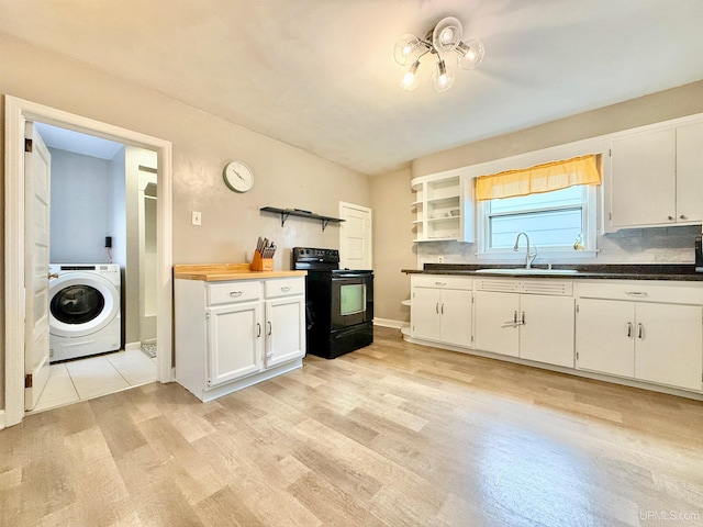 kitchen featuring black range with electric cooktop, sink, light hardwood / wood-style flooring, washer / clothes dryer, and white cabinetry