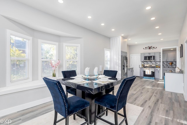 dining area with light hardwood / wood-style floors