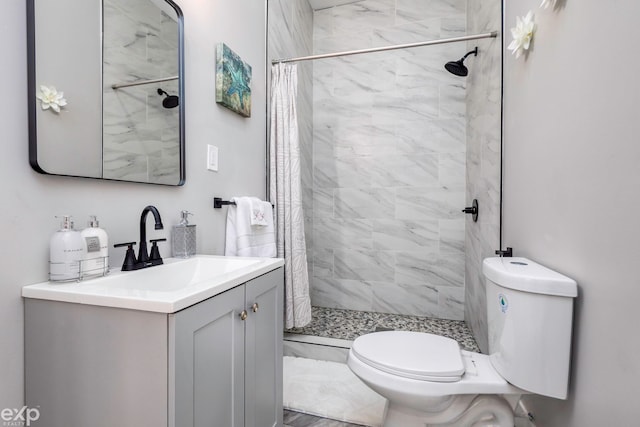 bathroom with vanity, toilet, and curtained shower