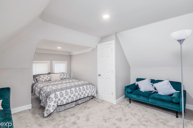 bedroom featuring light colored carpet and lofted ceiling