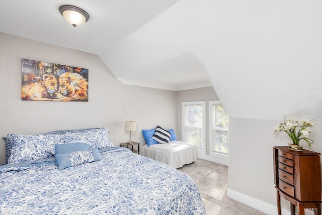 bedroom with light carpet and vaulted ceiling