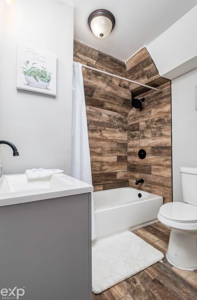 bathroom with hardwood / wood-style flooring, toilet, and shower / tub combo with curtain