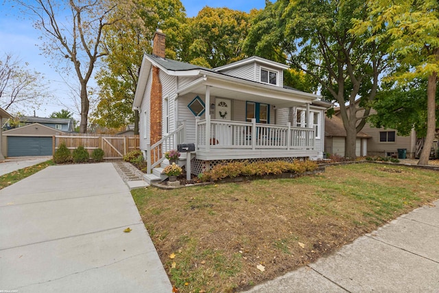 bungalow-style house featuring a front lawn and covered porch