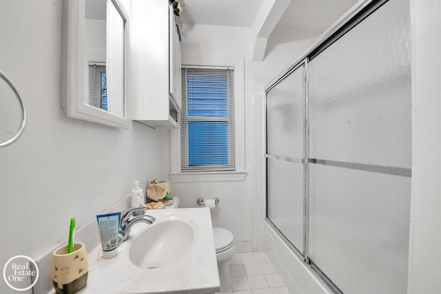 full bathroom featuring tile patterned flooring, vanity, toilet, and shower / bath combination with glass door