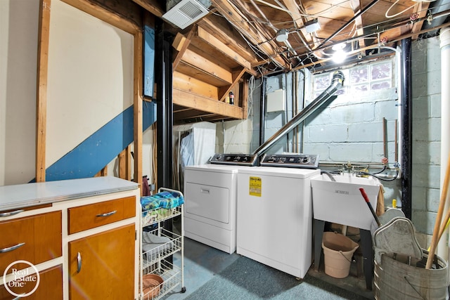 laundry area with washing machine and clothes dryer and sink