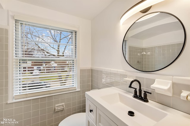 bathroom featuring vanity and tile walls