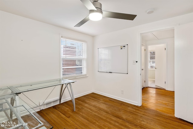 empty room featuring ceiling fan and hardwood / wood-style floors