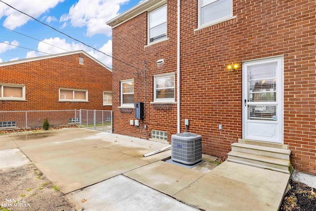 exterior space featuring central air condition unit and a patio