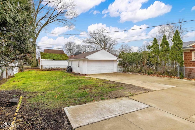 view of yard featuring a garage and an outbuilding