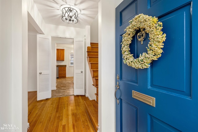 interior space with an inviting chandelier and light hardwood / wood-style flooring