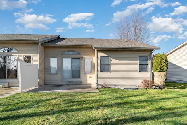 view of front of house with a patio area and a front yard