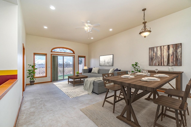 dining space with light carpet and ceiling fan