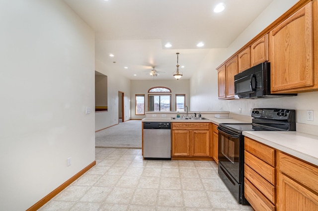 kitchen featuring kitchen peninsula, ceiling fan, sink, black appliances, and pendant lighting