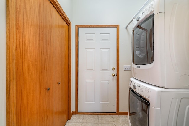 washroom featuring stacked washer / drying machine