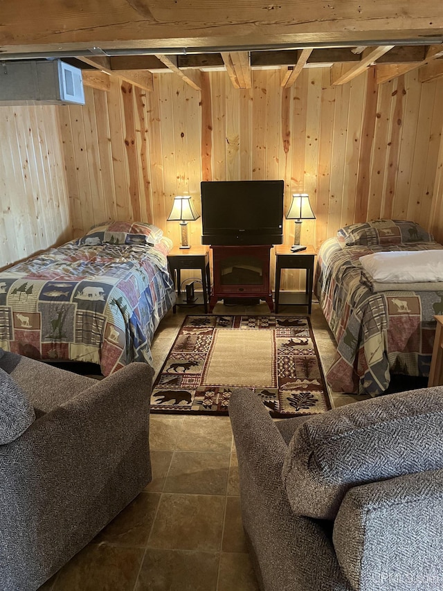 bedroom with tile patterned floors and wooden walls