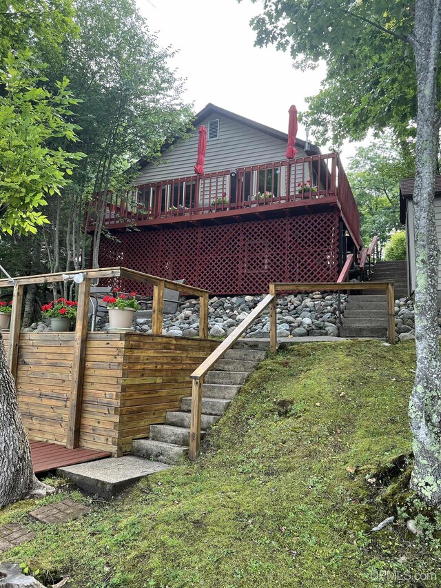 rear view of house featuring a deck