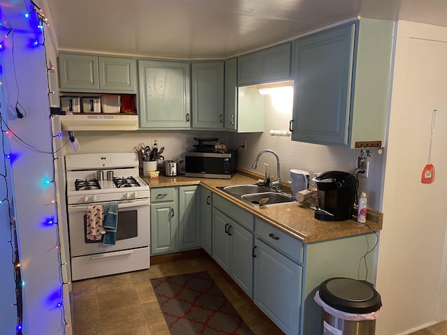 kitchen featuring sink, white gas range oven, and exhaust hood