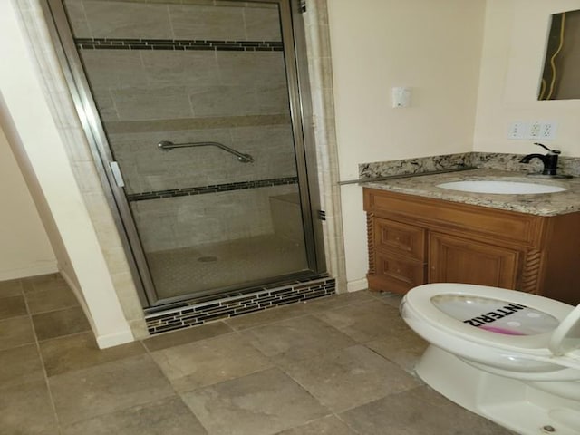 bathroom featuring vanity and a shower with shower door