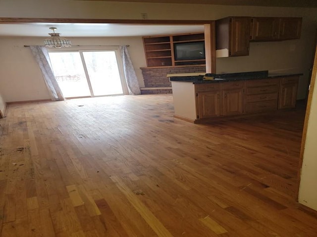 kitchen with hardwood / wood-style floors and kitchen peninsula