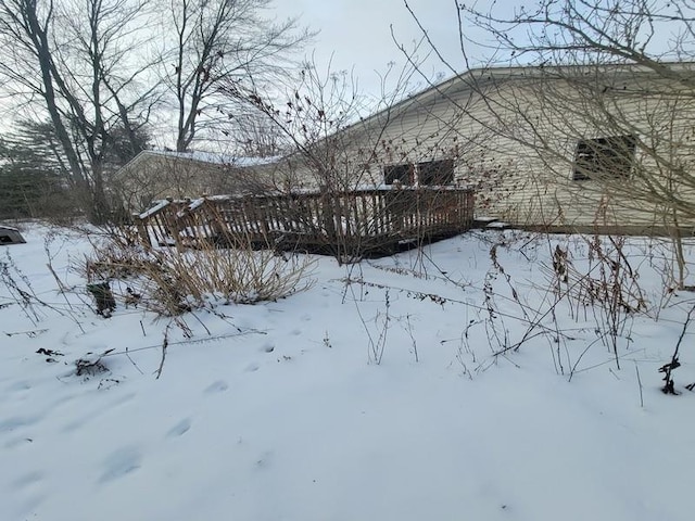 snow covered property featuring a deck