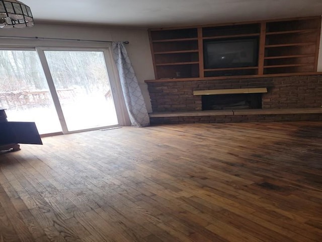 unfurnished living room with dark hardwood / wood-style flooring and a fireplace