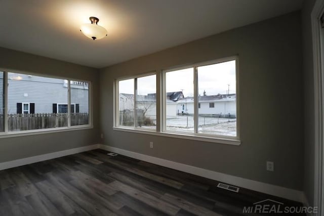 spare room with dark hardwood / wood-style flooring