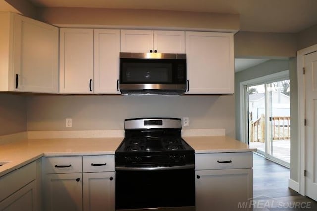 kitchen featuring white cabinets, wood-type flooring, and stainless steel appliances