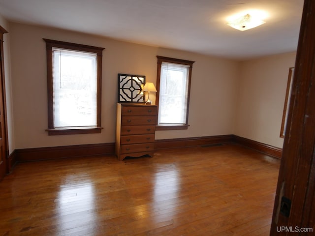 spare room featuring wood-type flooring