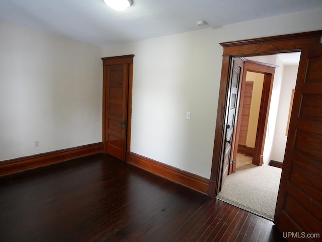 empty room featuring dark wood-type flooring