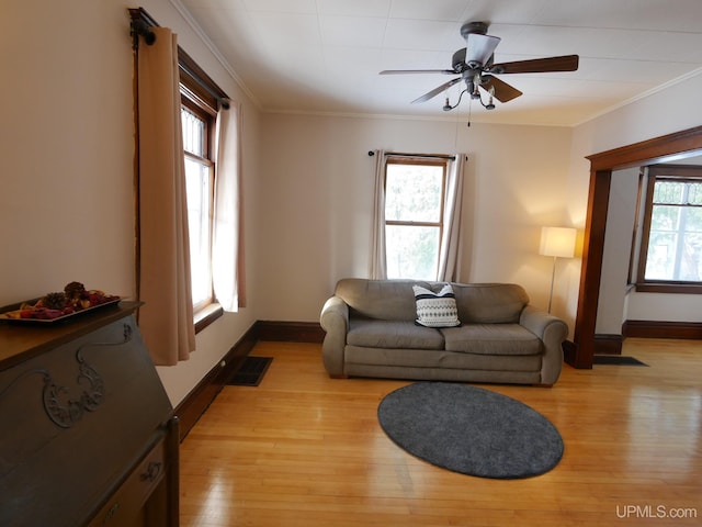 living room with ceiling fan, light hardwood / wood-style floors, and ornamental molding