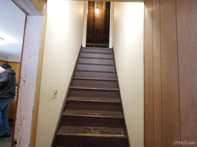 stairway with wood walls