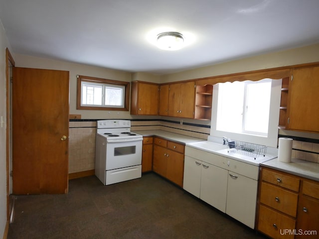 kitchen with white electric range, tasteful backsplash, and sink