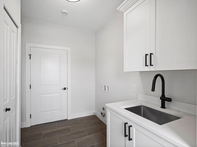 laundry room with washer hookup, sink, cabinets, and hookup for an electric dryer