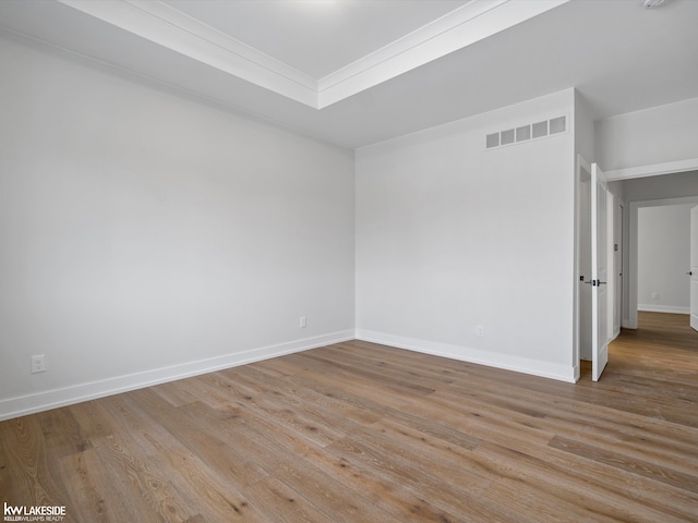 unfurnished room with ornamental molding and light hardwood / wood-style flooring