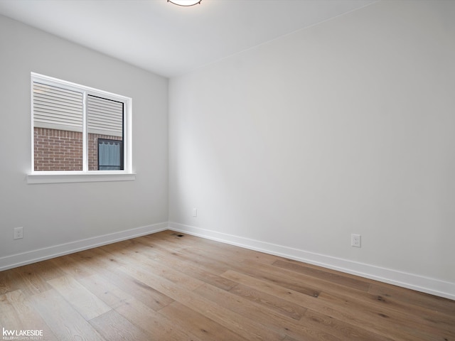 spare room with light hardwood / wood-style floors